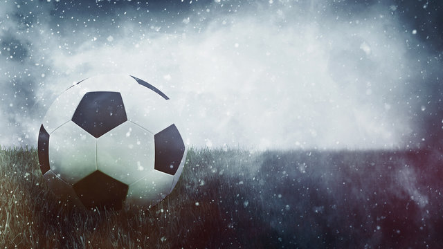 Soccer ball in grass as grunge sports background