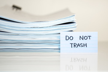 Do Not Trash; Stack of Documents on white desk and Background.