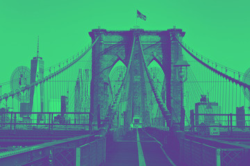Obraz premium Brooklyn Bridge with flag on top. Duotone style.