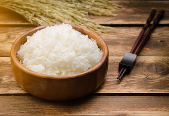 Cooked rice and paddy rice on wood