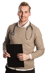 A handsome surgeon with a stethoscope around his neck holding a clipboard and smiling towards camera. White background.