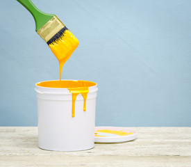 White plastic bucket with yellow color paint on wood, © showcake