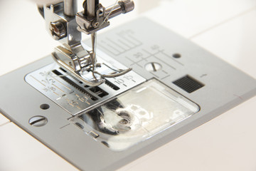 The sewing on the sewing machine turquoise fabric