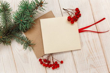 Christmas mokup.Tree branch frame, empty cards with rowanberry .White wooden table.