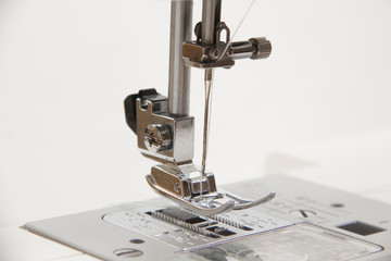 The sewing on the sewing machine turquoise fabric