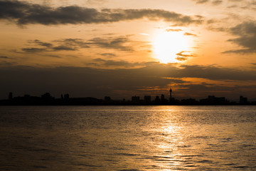 Naklejka premium view of city shadow with sunset at morning , look from sea.