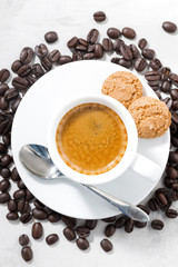cup of espresso and almond cookies, top view vertical closeup