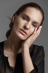 Fashion style model in black shirt and pants posing in the studi