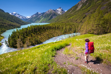 Fototapeta na wymiar Woman hike with backpack at the lake of highlands of Altai mount