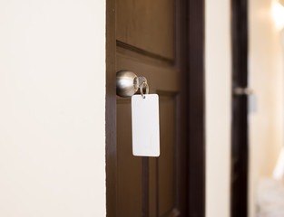 house key with hotel card and hotel door
