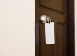 house key with hotel card and hotel door