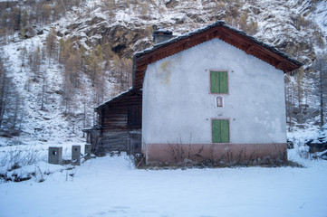 chalets, mountain house, with snow and snow-covered trees. colorful trees and ancient wooden houses