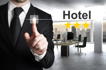 businessman in modern office pushing touchscreen hotel rating