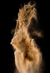 Sandy explosion isolated on over dark background,