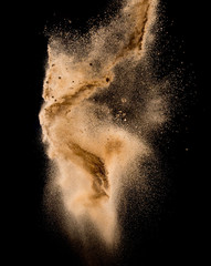 Sandy explosion isolated on over dark background,