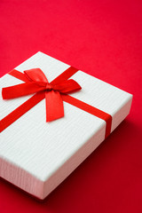 White gift box on red background

