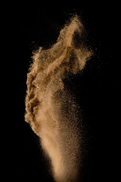 Sandy explosion isolated on over dark background,