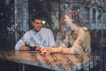 Two young friends talking in the cafe