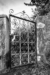 Old metal fence gate with cross