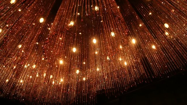 large orange chandelier of glass with reflections