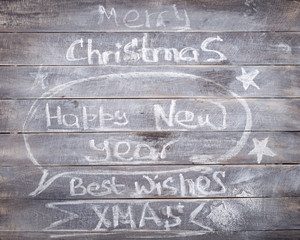 Christmas New year Chalk inscriptions on the wooden background