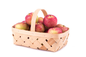 Fresh apples in a wooden basket, on white background