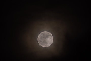 Rare full moon not seen since 1948 through a veil of high clouds