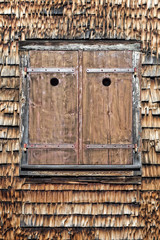 Wooden window shutters of traditional swiss farmhouse