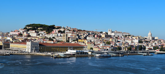 Fototapeta na wymiar Panoramic view of port of Lisbon with old city and historical buildings. Skyline of Alfama - the old district of Lisbon, Portugal.