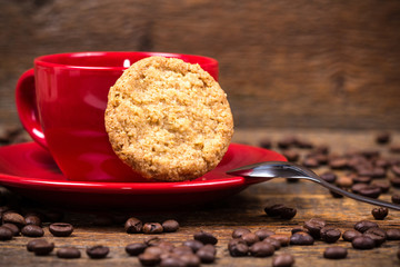 Coffee cup with biscuit and coffeebeans