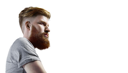 Close-up portrait of bearded man in t-shirt. Serios man with thinking face. Hipster guy in studio on white background.