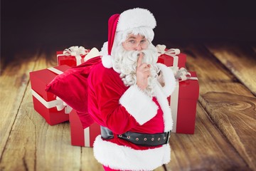 Portrait of santa claus with finger on lips