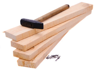 Boards, nails and hammer on white background.