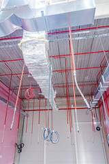 Fire sprinkler system with red pipes is placed to hanging from t