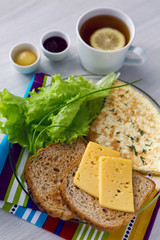 Breakfast with scrambled eggs on a transparent plate toast