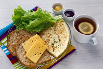 Breakfast with scrambled eggs on a transparent plate toast