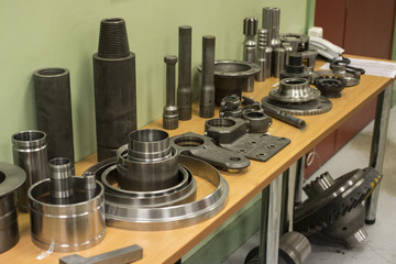 Industrial lathe tool and high precision cnc turning parts. high precision automotive machining mold and die part. CNC prosessed parts on table.