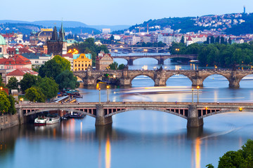 Fototapeta na wymiar Panorama of the old part of Prague from the Letna park at dusk. Beautiful view on the bridges over the river Vltava at sunset. Old Town architecture, Czech Republic.