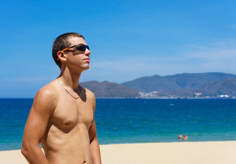 sexy man posing on a beach