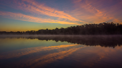 Abstract sunrise over water reflection