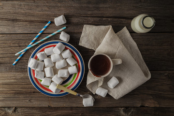 Cup of hot cocoa with marshmallows on the wooden table, top view