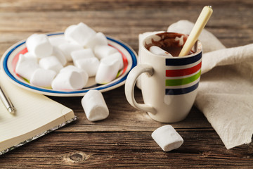 Hot drink with marshmallows on the background of Christmas decor