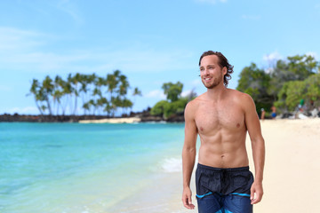 Handsome young man looking away on summer beach vacation. Portrait of an attractive caucasian male...