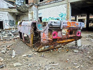 Fototapeta na wymiar destroyed rusty van body overturned in urban ghetto