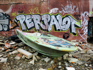 Vintage old boat destroyed in urban ghetto