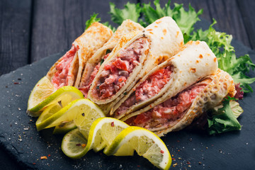 Rolls of thin pancakes with smoked salmon