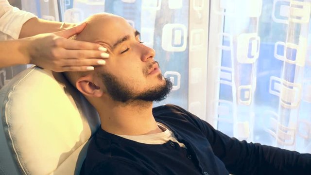Man receiving head massage in medical office