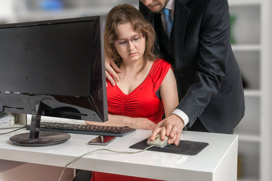 Boss or manager is seducting his secretary in office. Harassment concept.