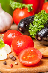 Fresh vegetables on a wooden table. Preparation. Healthy diet. Ripe. Eggplants, tomatoes, pepper, garlic.