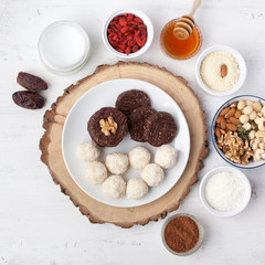 Raw vegan paleo style cookies selection, made with nuts, coconut oil, honey and dates, top view, selective focus on walnut